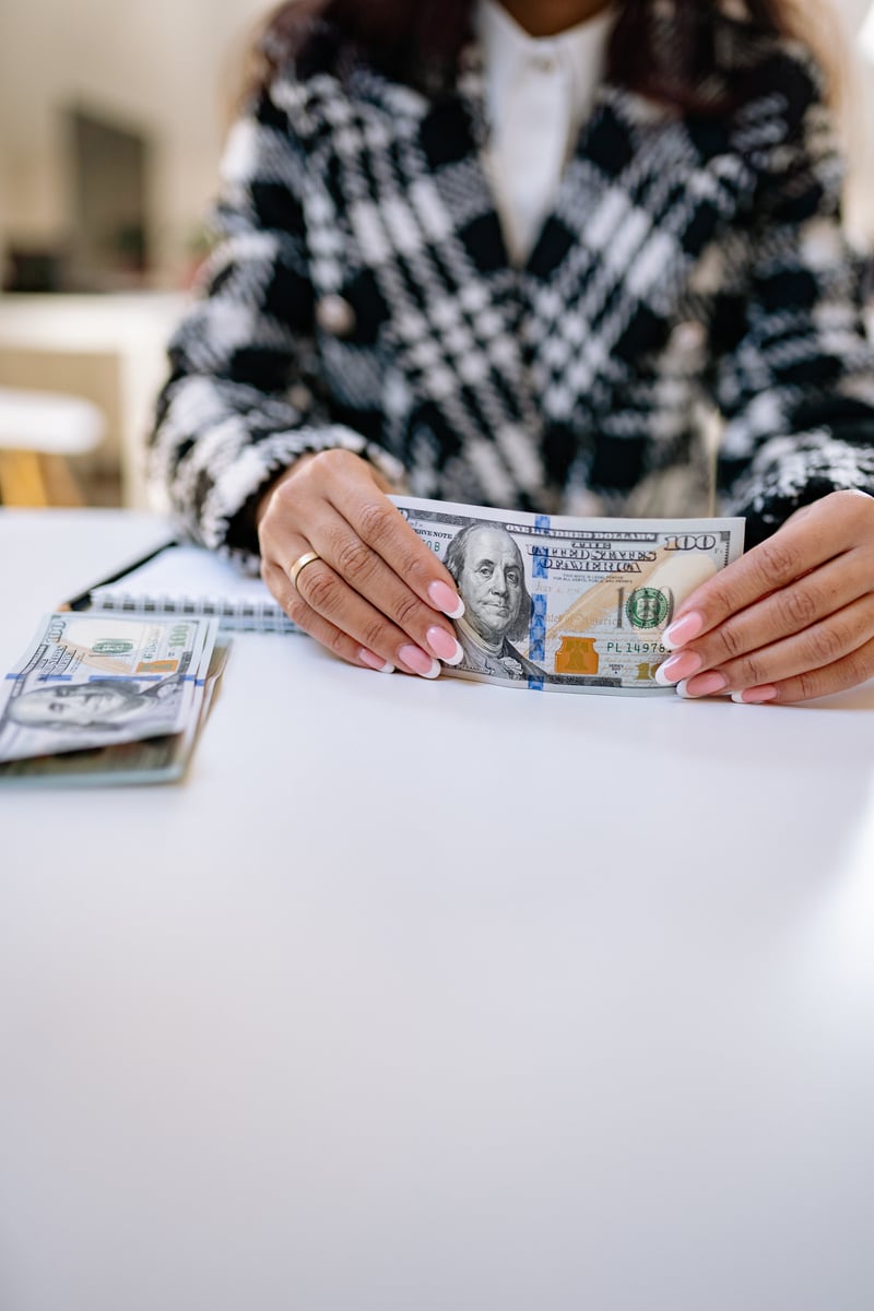 Person Holding 100 U.S. Dollar Bill